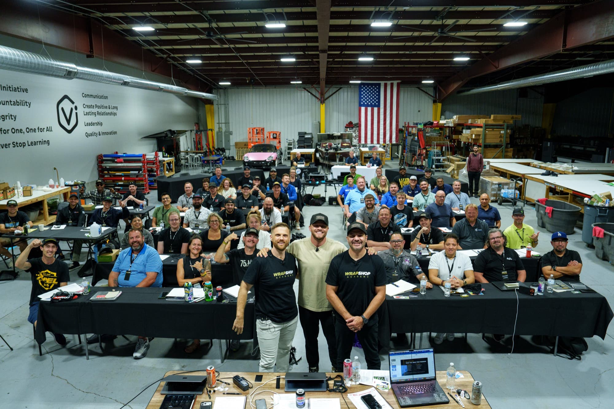 A full room of wrap shop owners at the Printing Profits Workshop, the three cofounders front and center